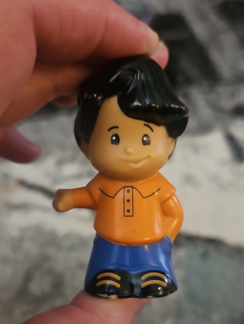 Fisher-Price Little People Koby figure wearing an orange shirt